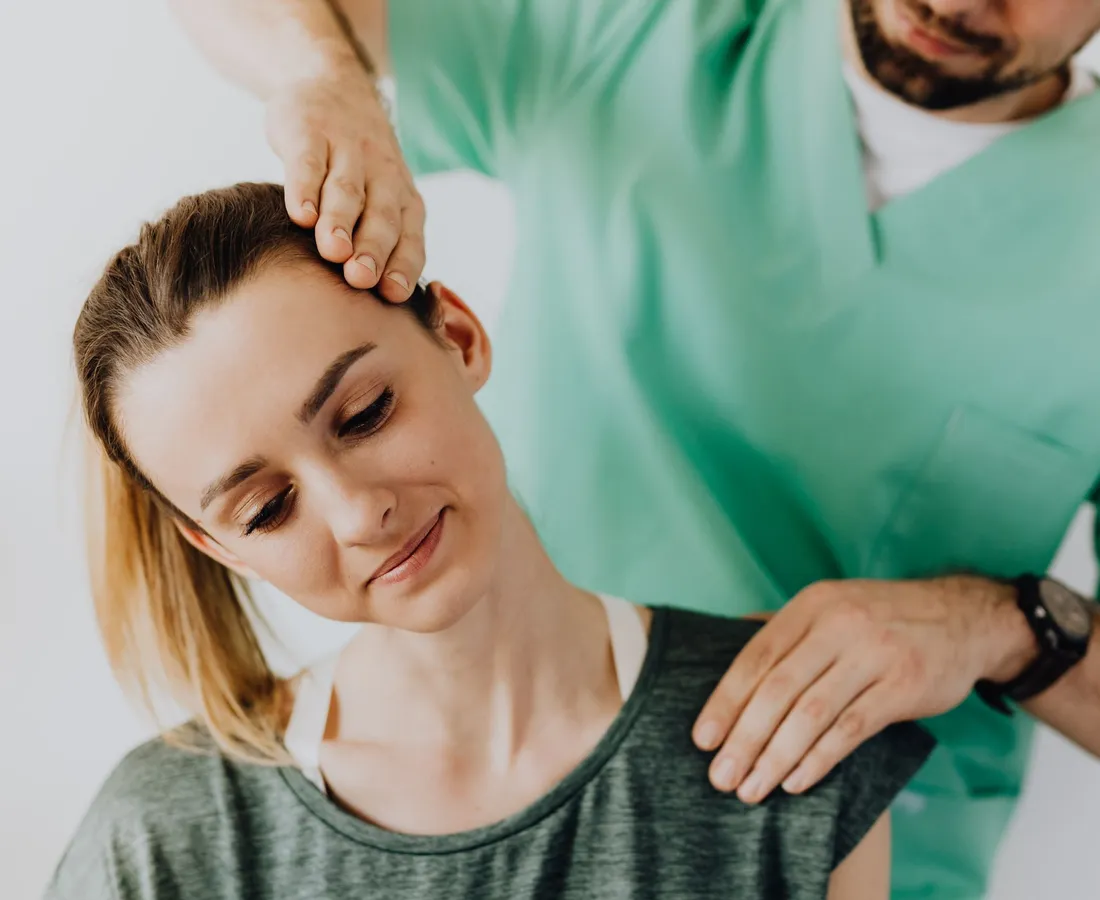 Smiling patient during a gentle neck and shoulder treatment